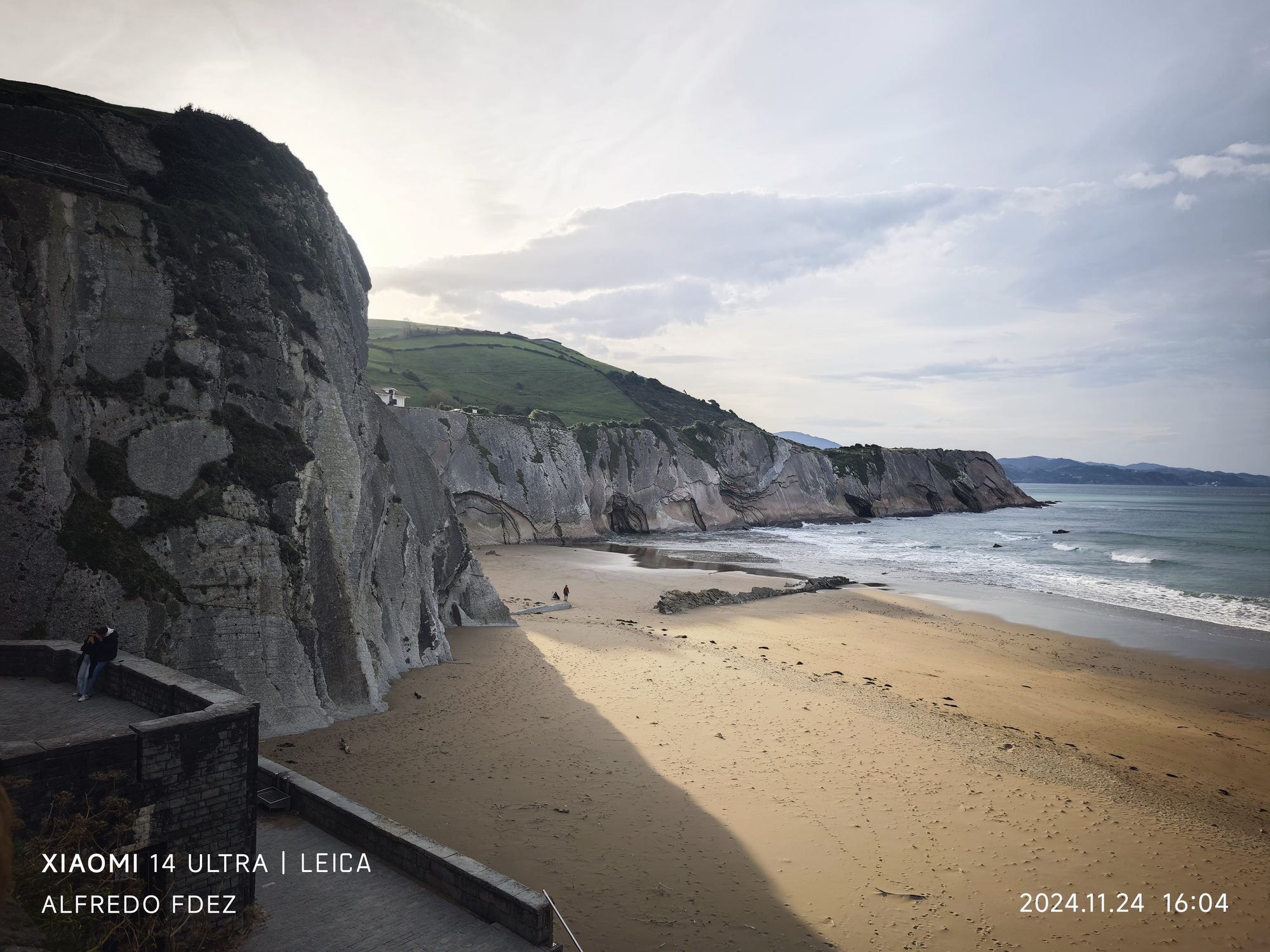 Acantilados de flysch sobre una playa de arena dorada y el mar en Zumaia.